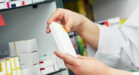 Pharmacist holding a box of tablets