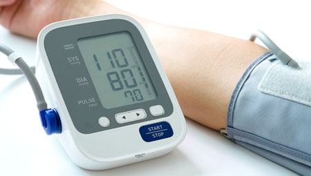 Blood pressure machine attached to a persons arm